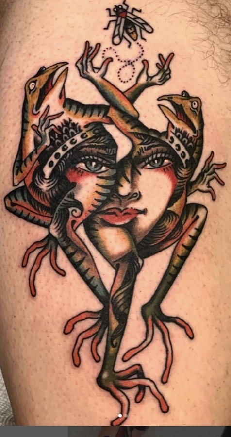 Traditional tattoo by Brandon Huckabey: two lizards framing a woman's face