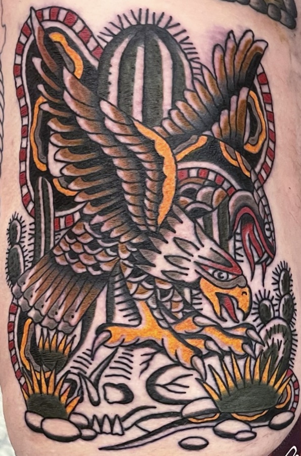 Traditional tattoo by Darin Roth: an eagle striking a rattlesnake among cacti